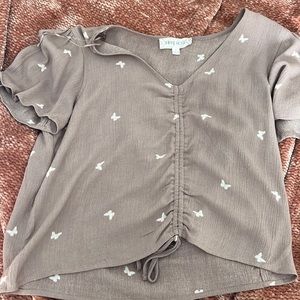 nude purple blouse with white butterflies and a scrunch down the middle